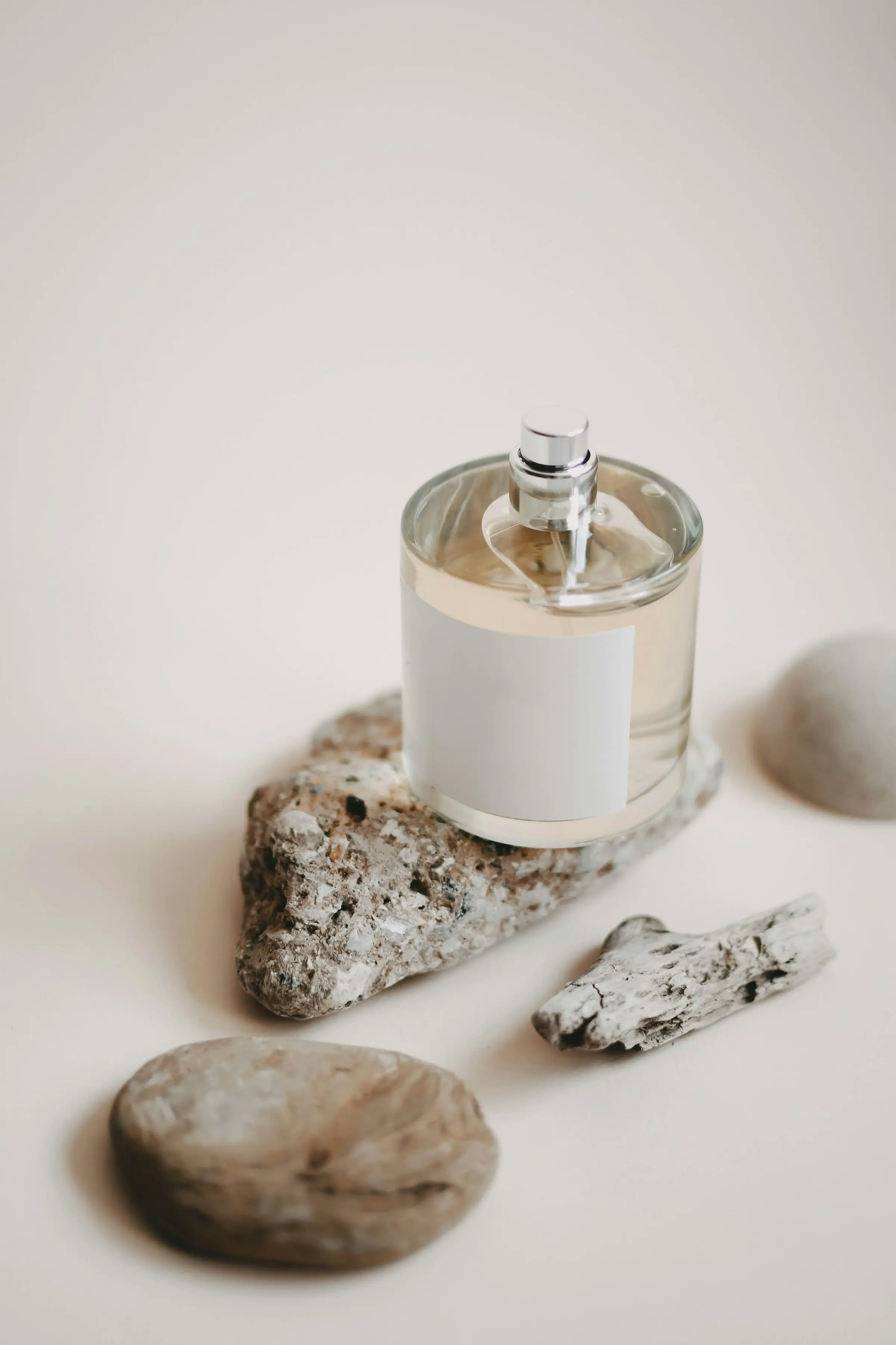 An unlabelled glass bottle resting on stone